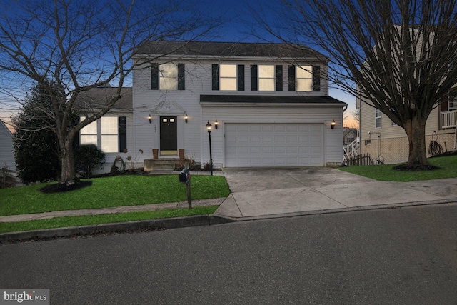 view of front facade with a garage and a yard