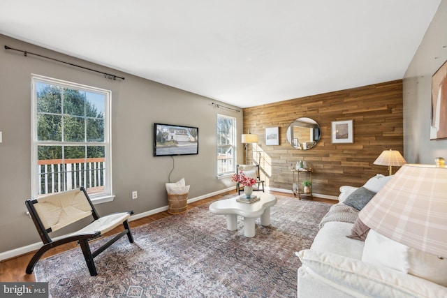 living room featuring hardwood / wood-style floors and wood walls