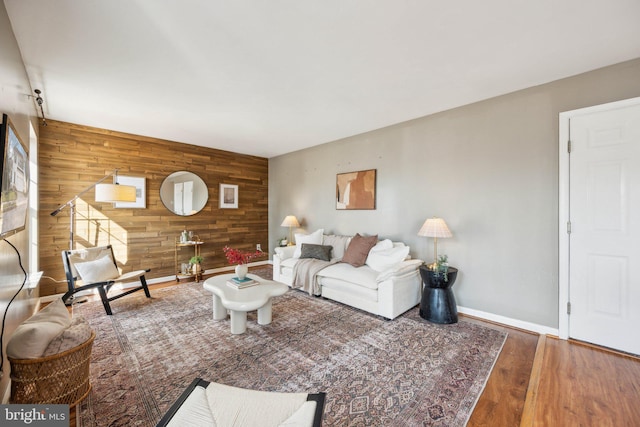 living room featuring hardwood / wood-style floors and wood walls