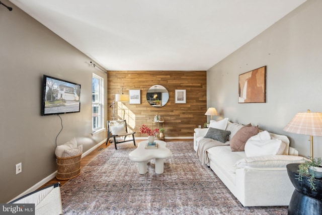 living room with dark hardwood / wood-style floors and wooden walls