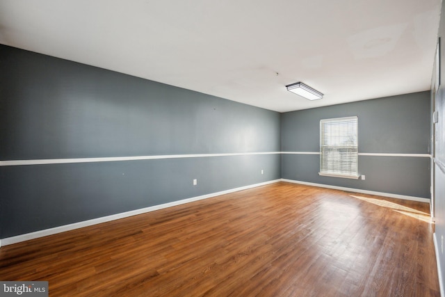 spare room with wood-type flooring