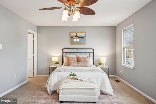 bedroom with ceiling fan and light carpet