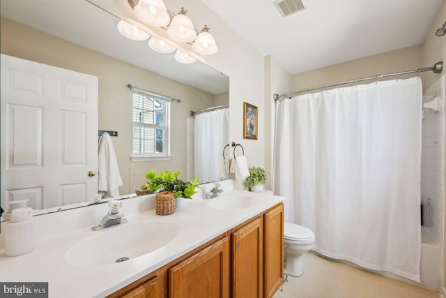 full bathroom with vanity, shower / tub combo with curtain, and toilet