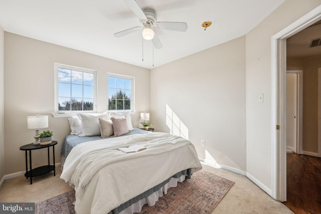 bedroom with light colored carpet and ceiling fan