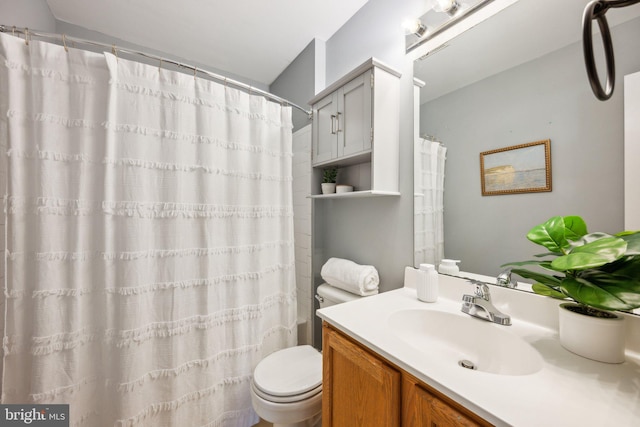 bathroom featuring vanity, toilet, and a shower with shower curtain