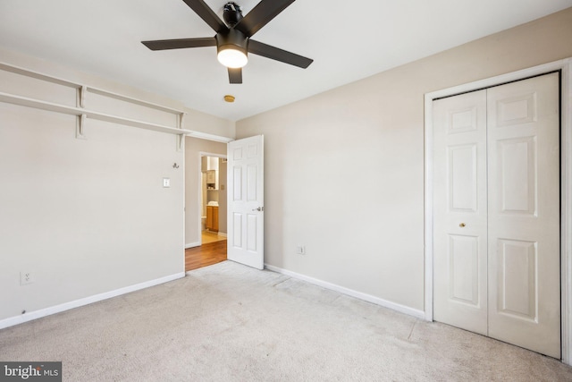 unfurnished bedroom with light carpet, ceiling fan, and a closet