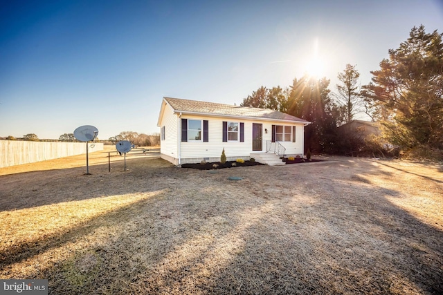 view of front of house featuring crawl space and fence