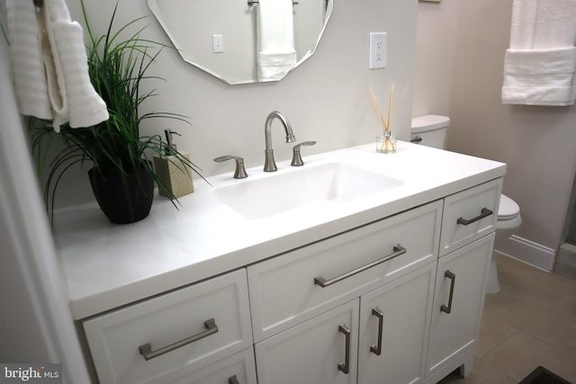 bathroom featuring vanity, tile patterned floors, and toilet