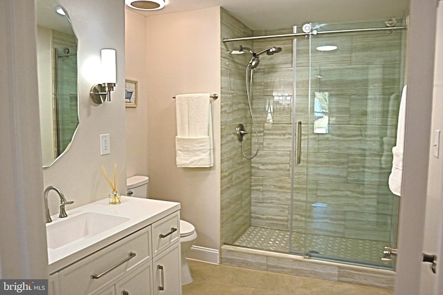 bathroom featuring vanity, toilet, and a shower with door