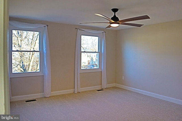 carpeted spare room with ceiling fan