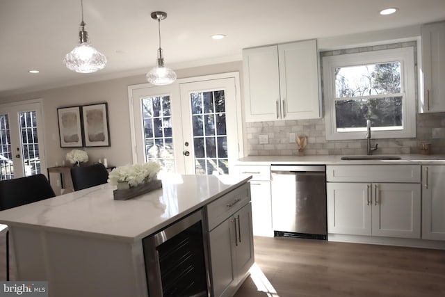 kitchen with stainless steel dishwasher, beverage cooler, white cabinets, and french doors