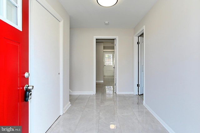 corridor featuring light tile patterned floors