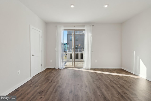 empty room with dark wood-type flooring