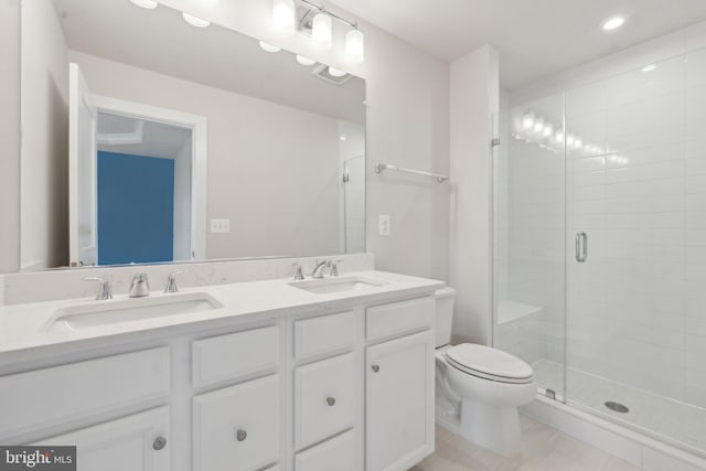 bathroom featuring vanity, an enclosed shower, and toilet