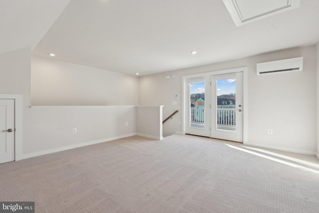 carpeted spare room with a wall mounted air conditioner