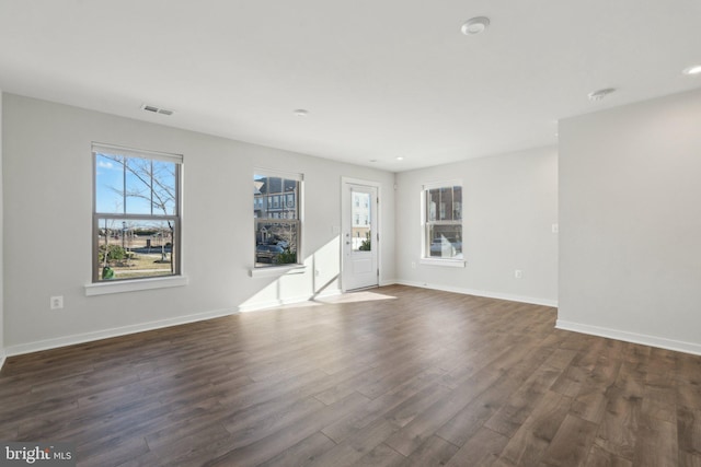 unfurnished living room with dark hardwood / wood-style flooring