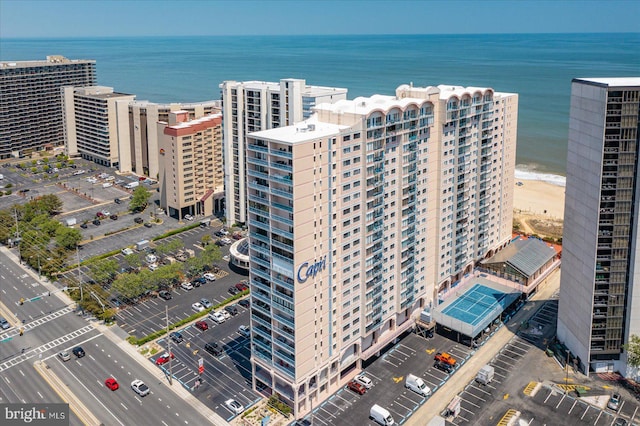 birds eye view of property featuring a beach view and a water view