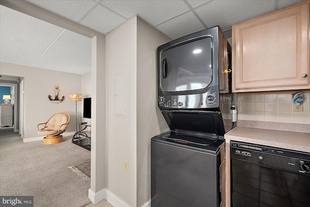 laundry area featuring stacked washer and clothes dryer and carpet