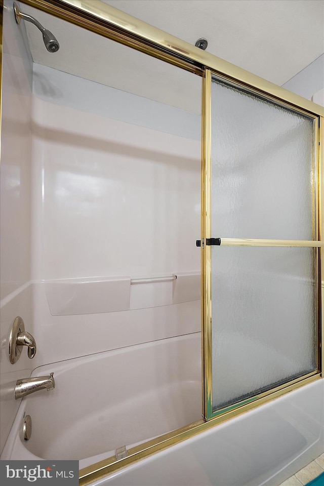 bathroom featuring combined bath / shower with glass door