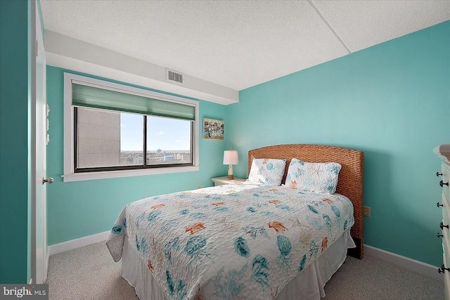 carpeted bedroom with a textured ceiling