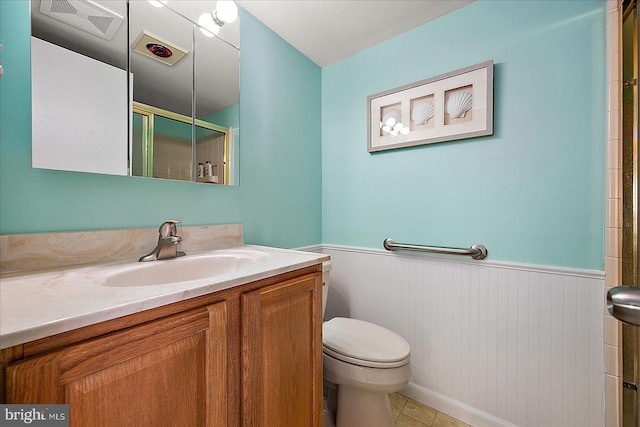 bathroom featuring vanity, toilet, and walk in shower