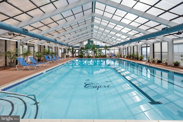 view of pool featuring glass enclosure