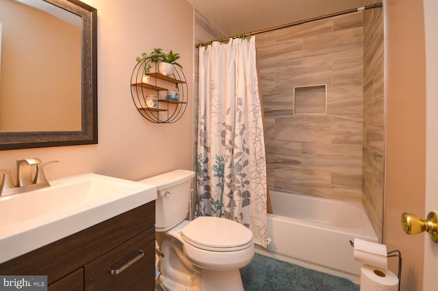 bathroom featuring toilet, shower / bath combo, and vanity