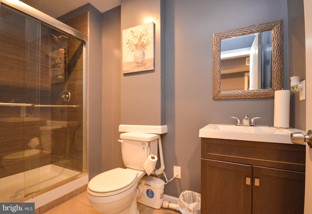 bathroom featuring toilet, a shower stall, tile patterned flooring, and vanity