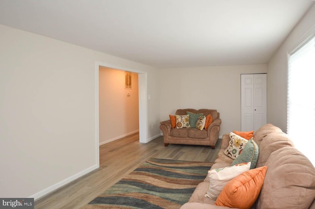 living room featuring light wood-type flooring and baseboards