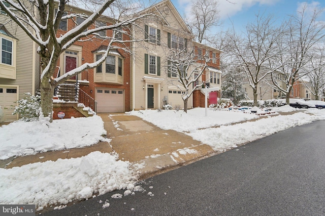 multi unit property featuring brick siding and an attached garage