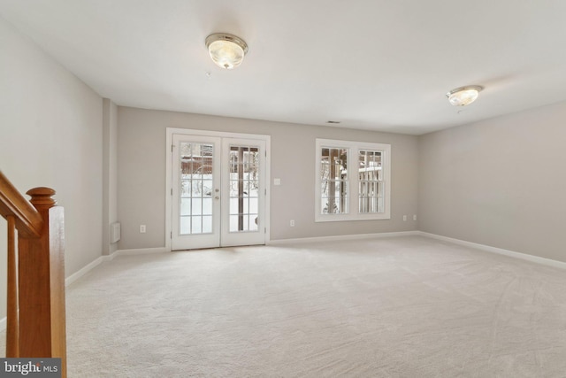 unfurnished room with light colored carpet and french doors