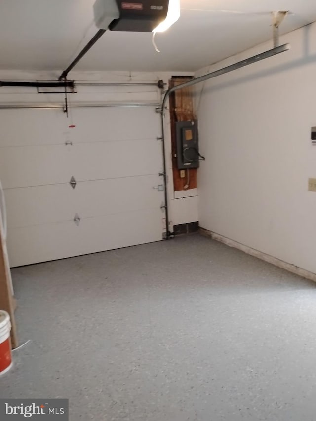 garage featuring a garage door opener and electric panel