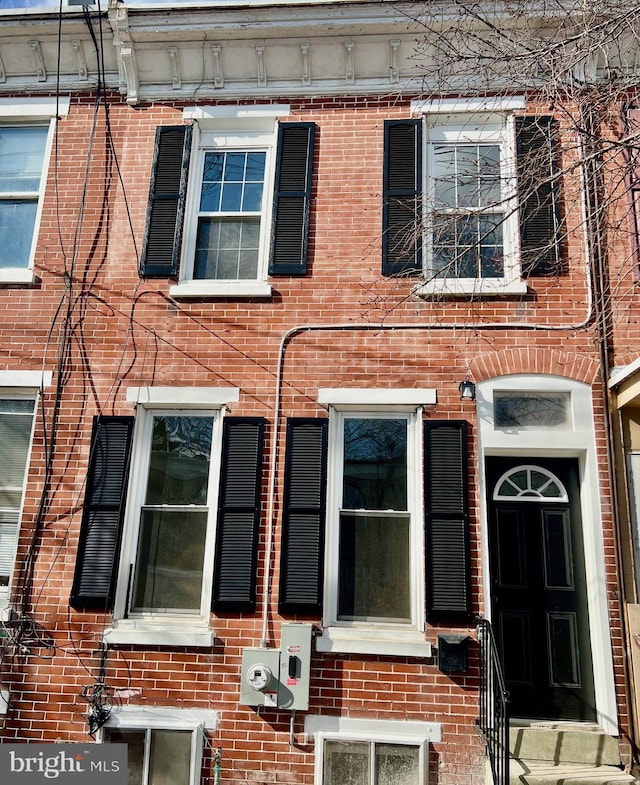 view of front of home featuring brick siding