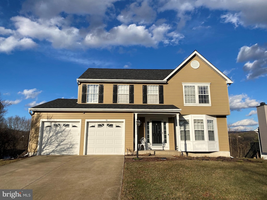 front facade with a garage and a front lawn