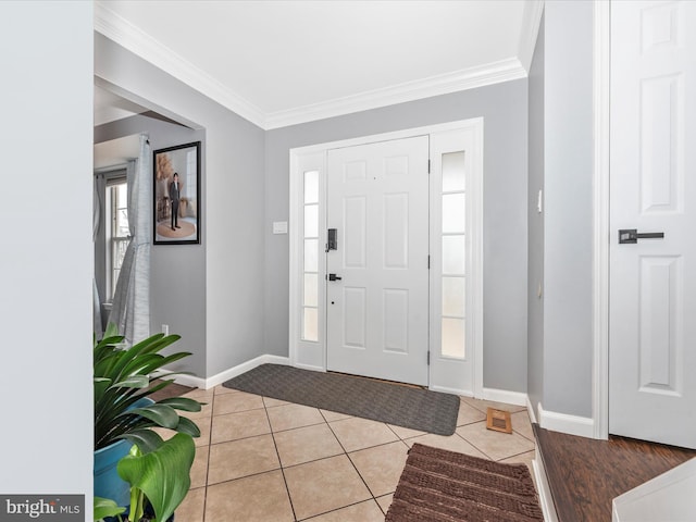 entryway with crown molding and light tile patterned floors