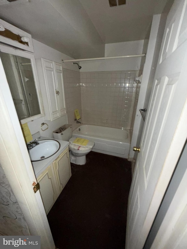 full bathroom with vanity, tiled shower / bath, and toilet