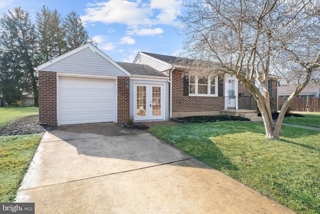 ranch-style home featuring a garage and a front lawn