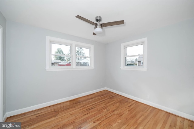 empty room featuring ceiling fan and light hardwood / wood-style floors