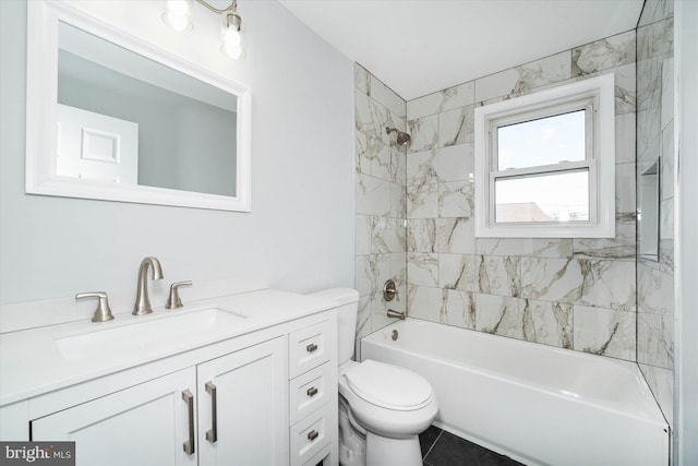 full bathroom with tiled shower / bath, vanity, and toilet