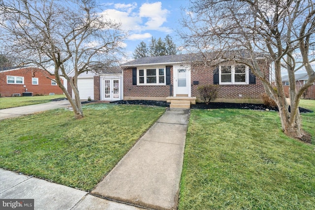 view of front of property featuring a garage, a front lawn, and french doors