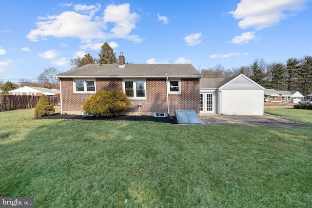 rear view of property featuring a lawn