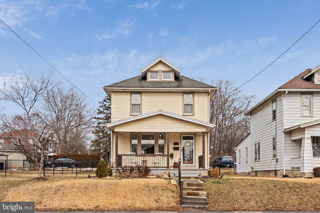 front of property with a porch and a front lawn