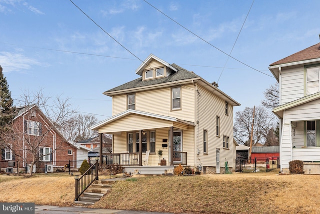 view of front property featuring a front lawn and covered porch