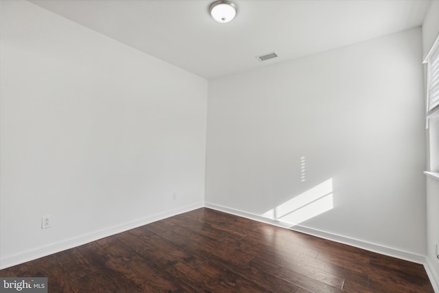 spare room with hardwood / wood-style floors