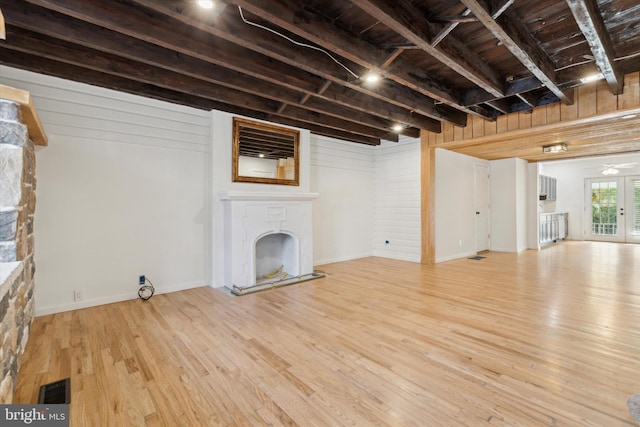 basement with french doors, wood ceiling, and light hardwood / wood-style flooring