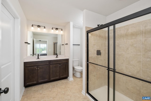 bathroom with walk in shower, vanity, tile patterned floors, and toilet