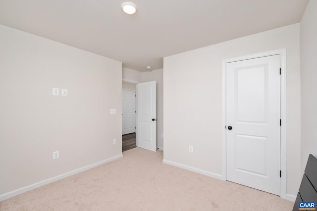 unfurnished bedroom with light colored carpet