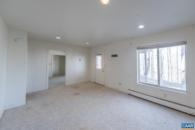 interior space with a baseboard radiator and light carpet