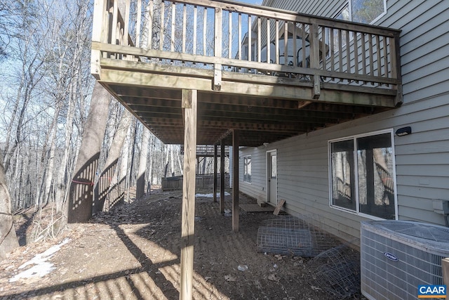 view of side of home with cooling unit and a deck