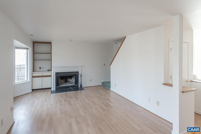 unfurnished living room with light wood-type flooring